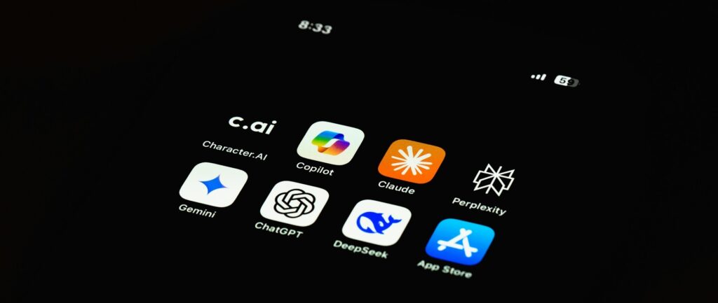 Fotografia em cores de tela de celular contendo diversos aplicativos de IA, incluindo DeepSeek, Claude e ChatGPT, entre outros.